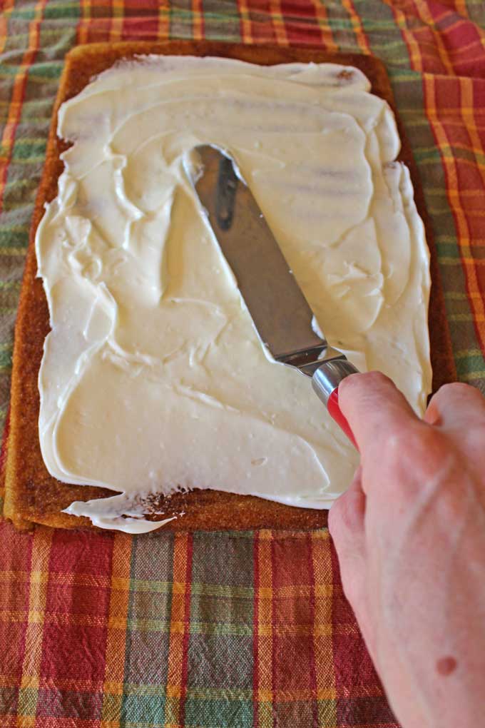 spreading filling onto cake with offset spatula