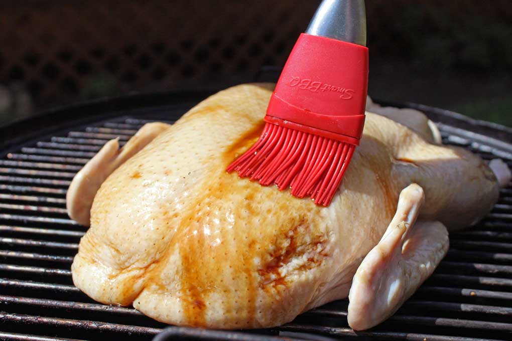 brushing the brown sugar glaze on the duck
