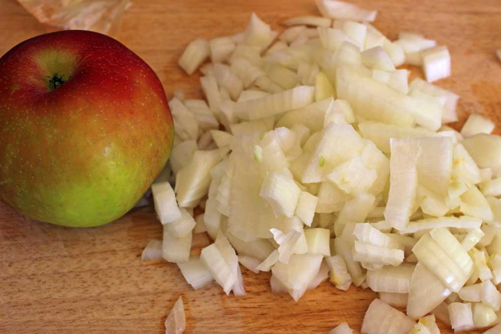 apple and chopped onion on cutting board