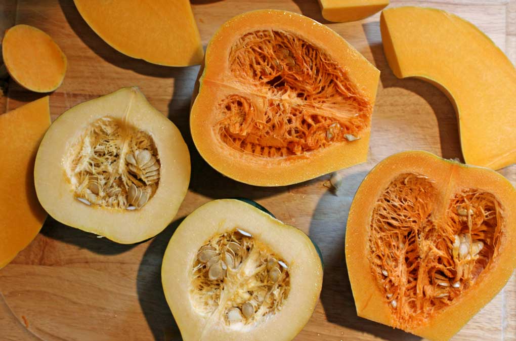 cut pumpkin and squash laying on cutting board