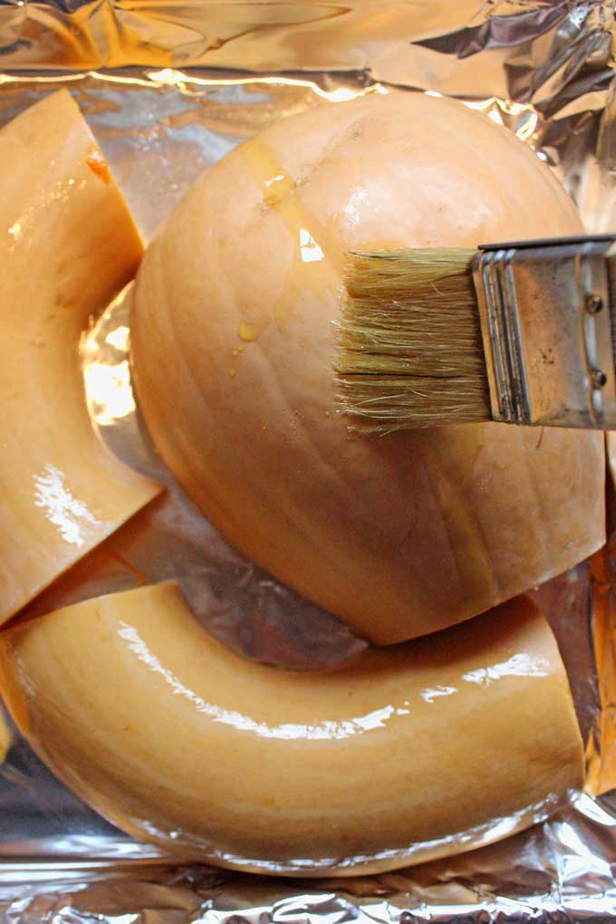 brushing neck pumpkin with oil