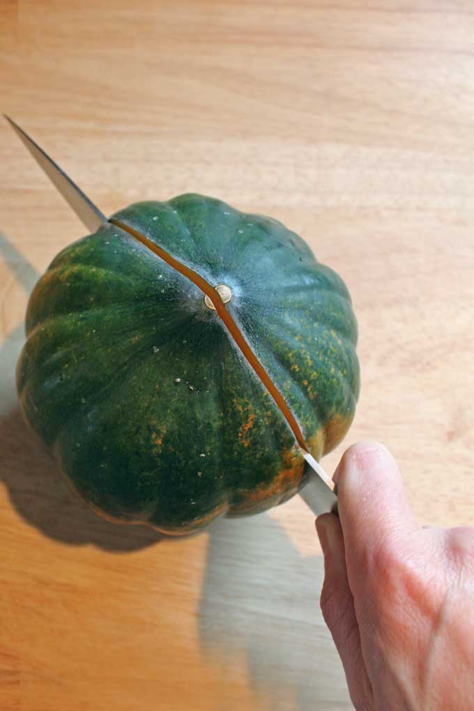 cutting the acorn squash in half