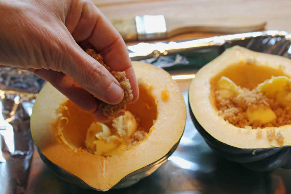 sprinkling brown sugar mixture inside acorn squash