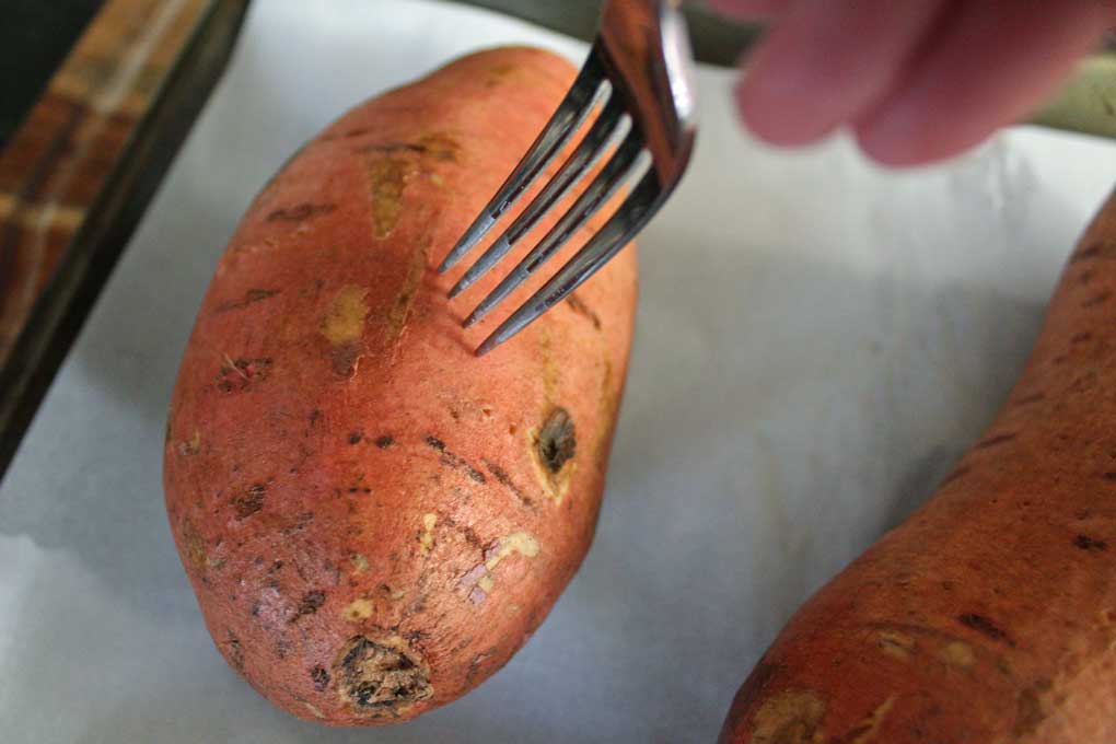 piercing sweet potato with fork
