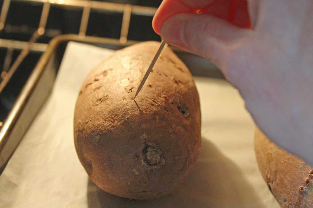 sticking toothpick into potato