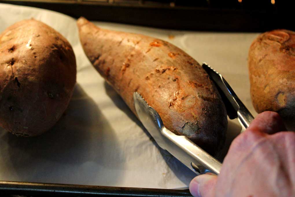 turning sweet potato over with tongs