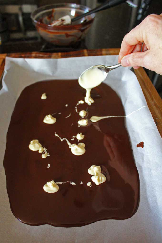 dolloping white chocolate onto dark chocolate