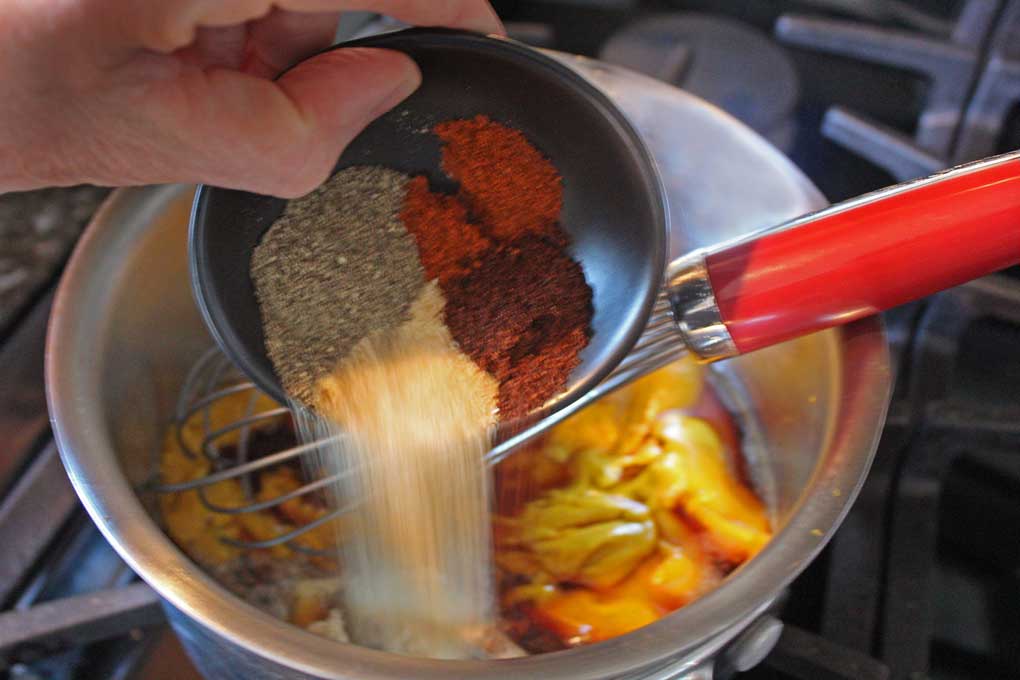 pouring spices into saucepan