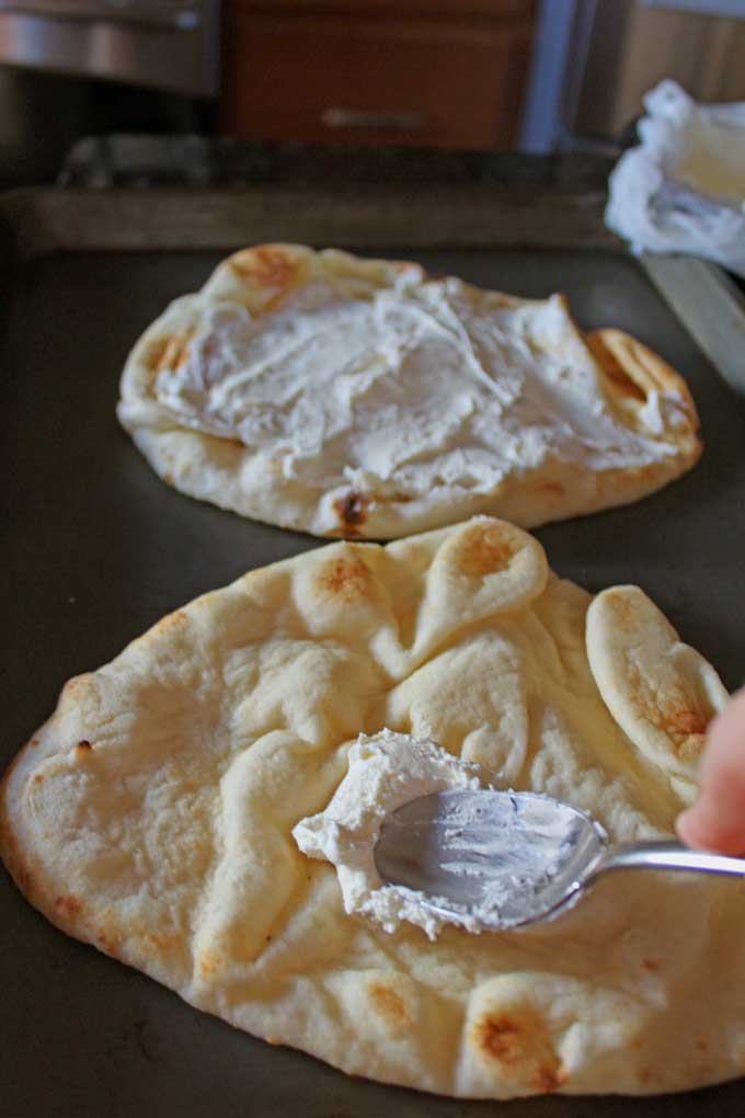 spreading ricotta onto flatbread
