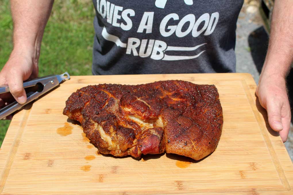 whole smoked pork belly on carving board