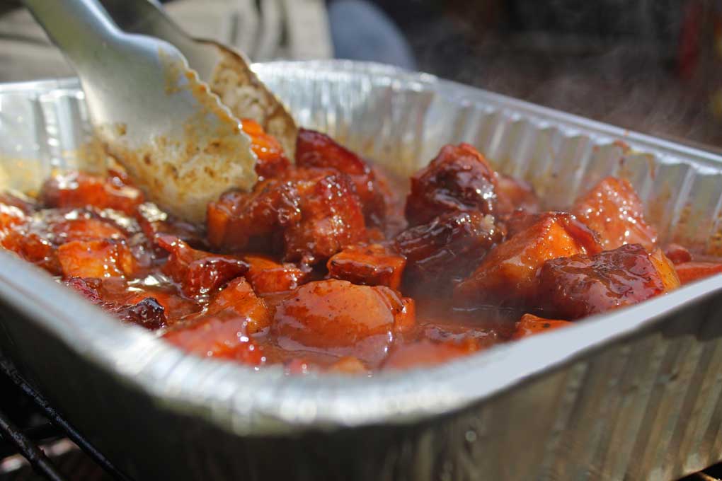 tossing burnt ends in sauce