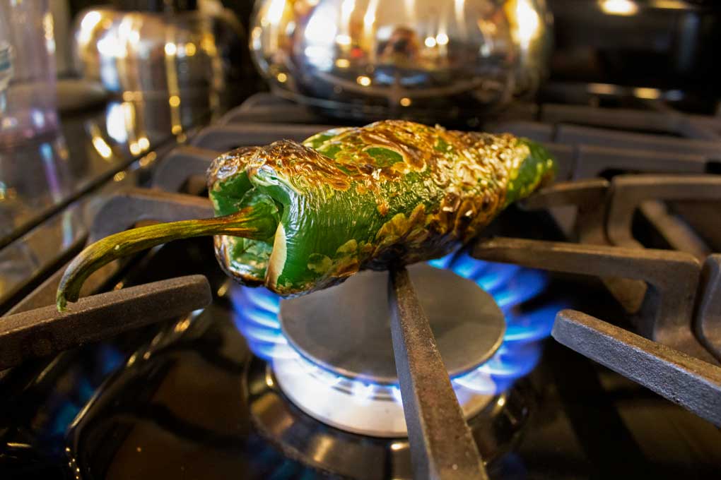 poblano fire roasting on stove