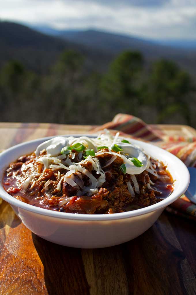 smoked brisket chili in bowl with mountain view