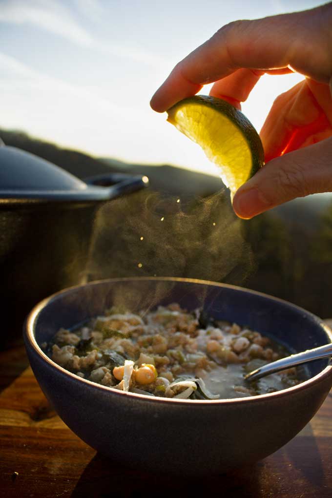 spritzing lime into white bean and pork chili