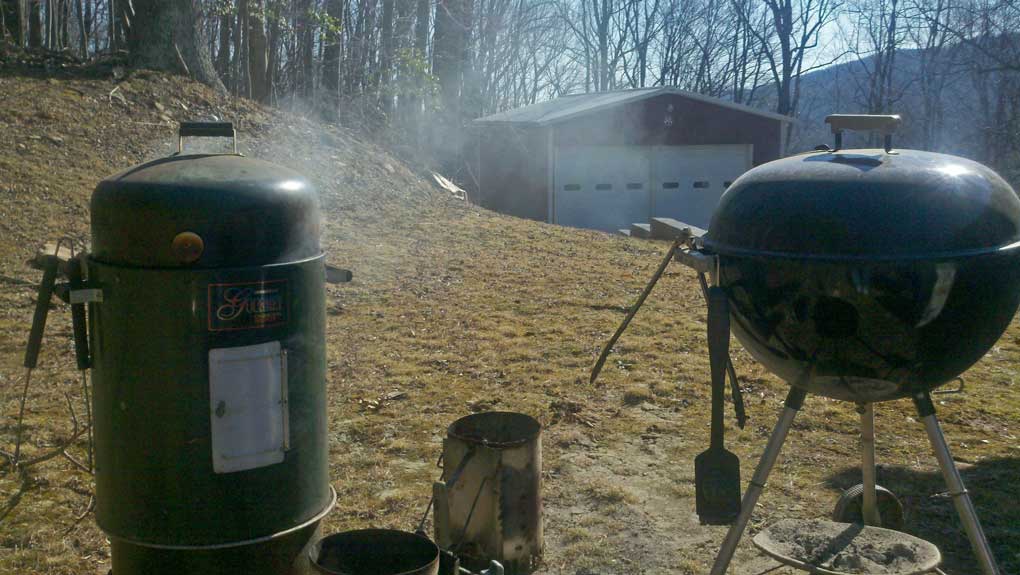 brinkman smoker and weber grill in yard