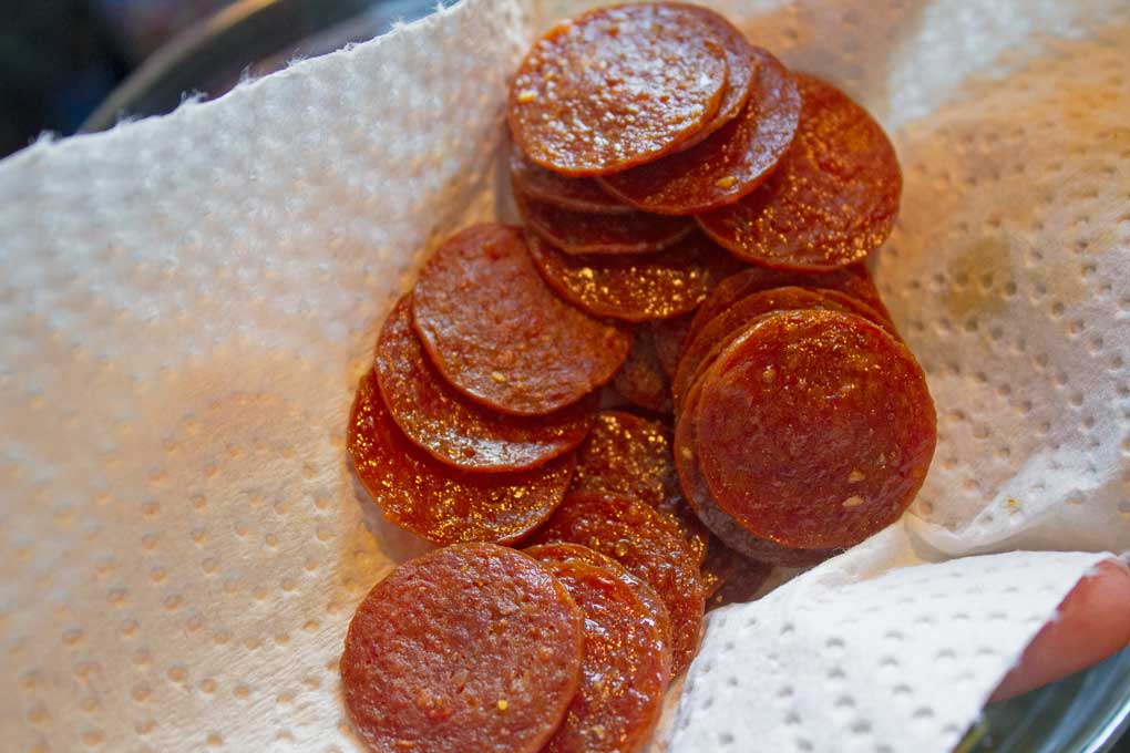 pepperonis for Caesar salad draining on paper towel