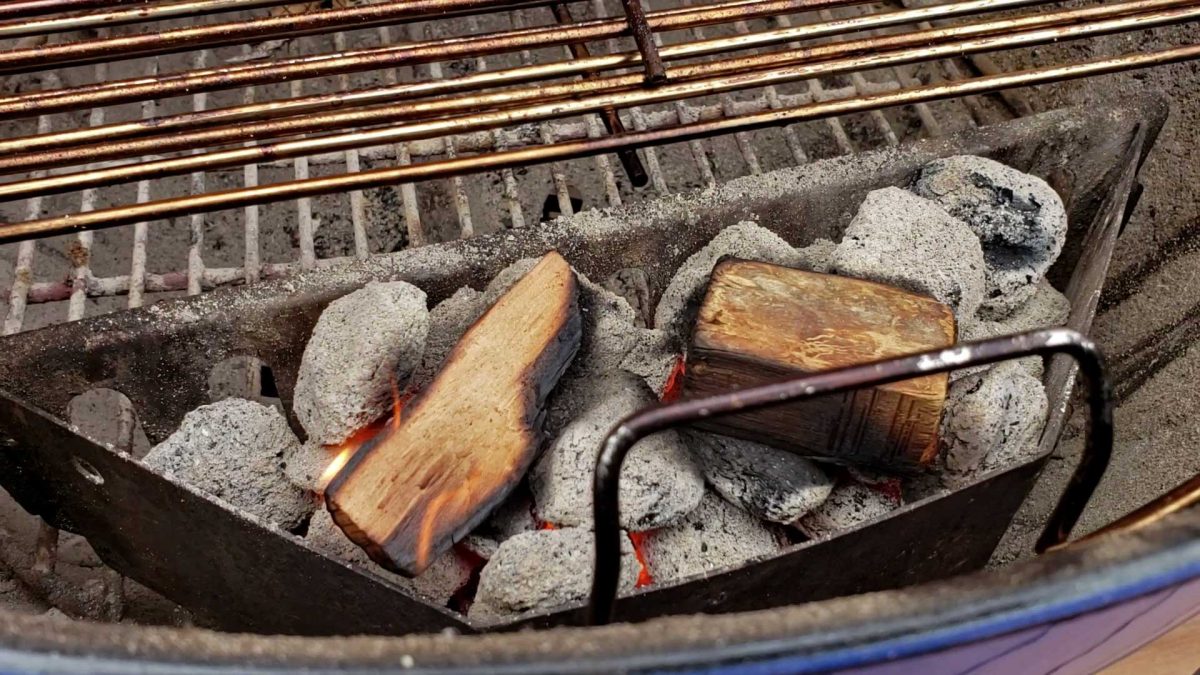 charcoal basket with coals and wood chunks