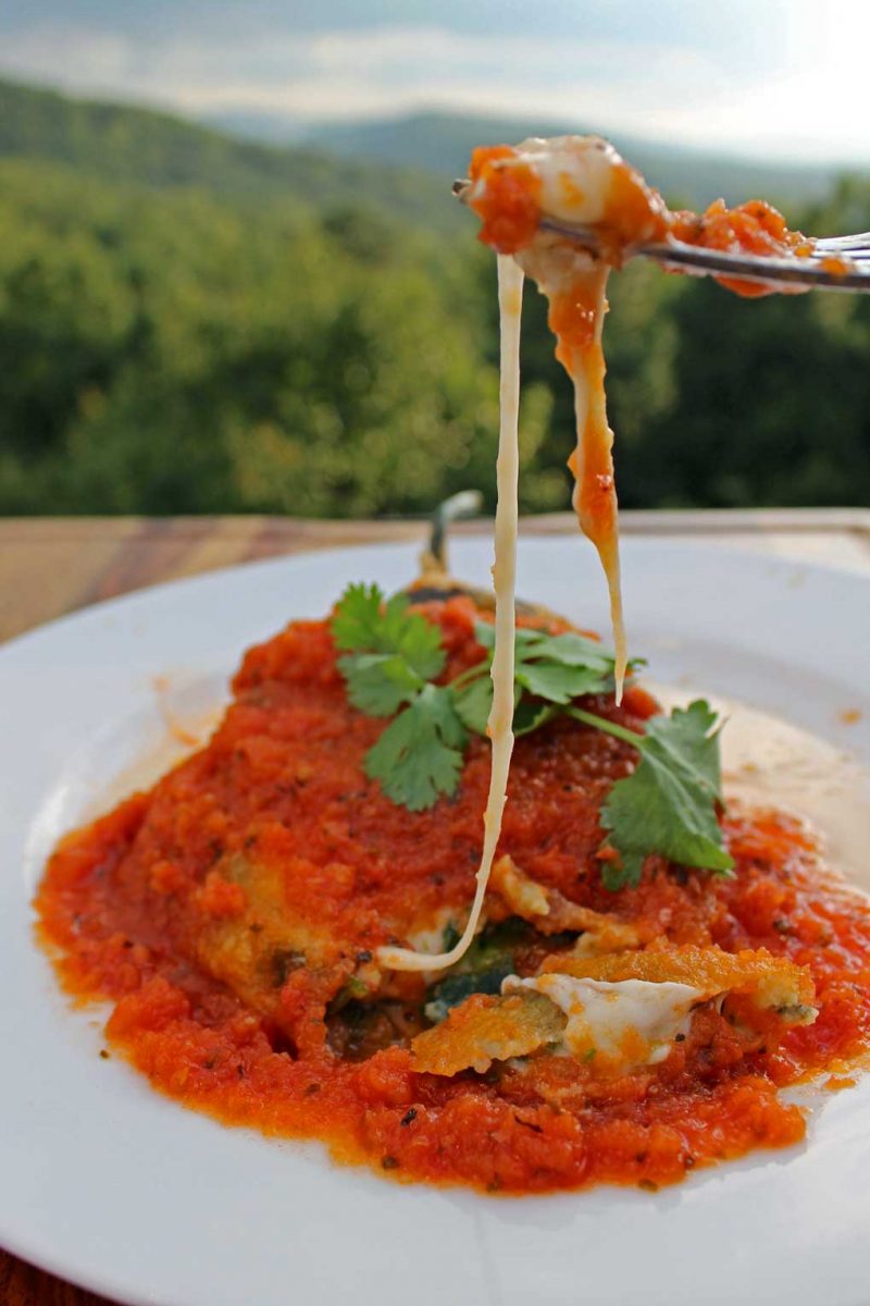 fork pulling cheese from authentic chiles rellenos