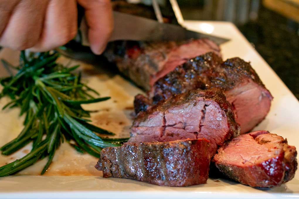 sliced smoked beef tenderloin on platter