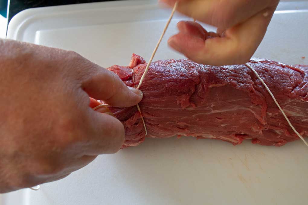 tying up the tail of tenderloin with twine