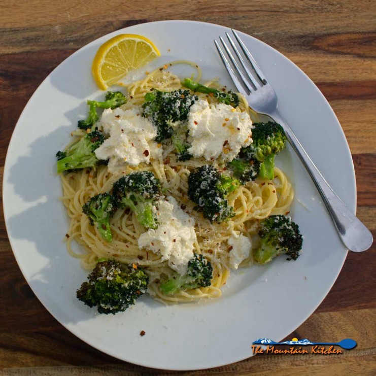 Air fryer broccoli with ricotta and pasta on a plate with fork