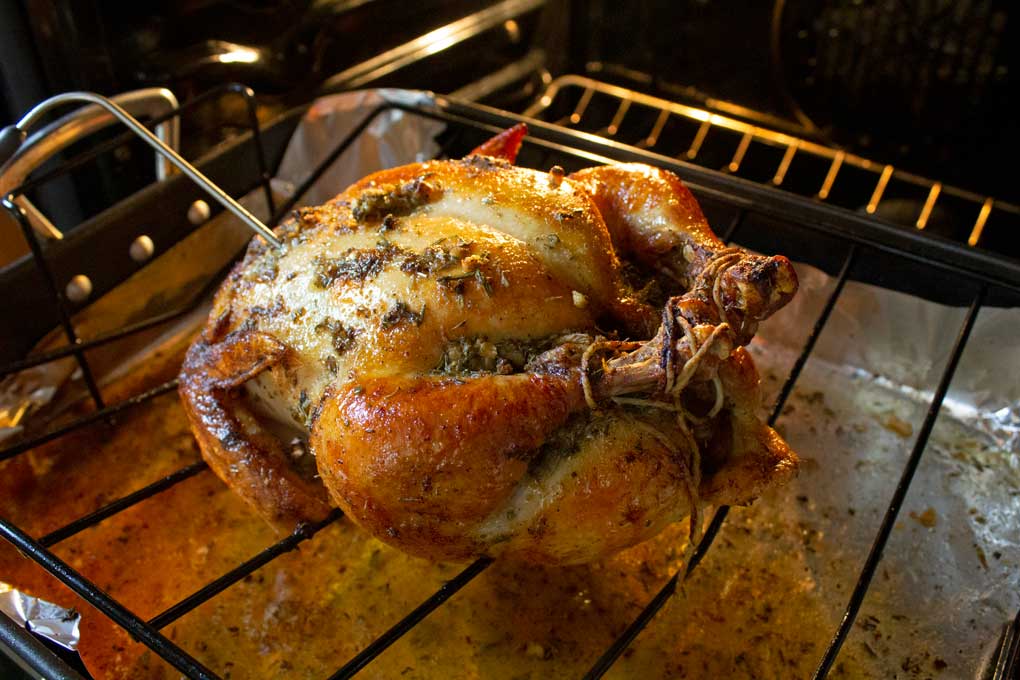 garlic herb-butter roasted chicken in roasting pan