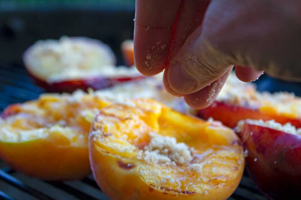 sprinkling peaches and plums with brown sugar