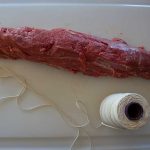 butcher's twine and tenderloin on cutting board