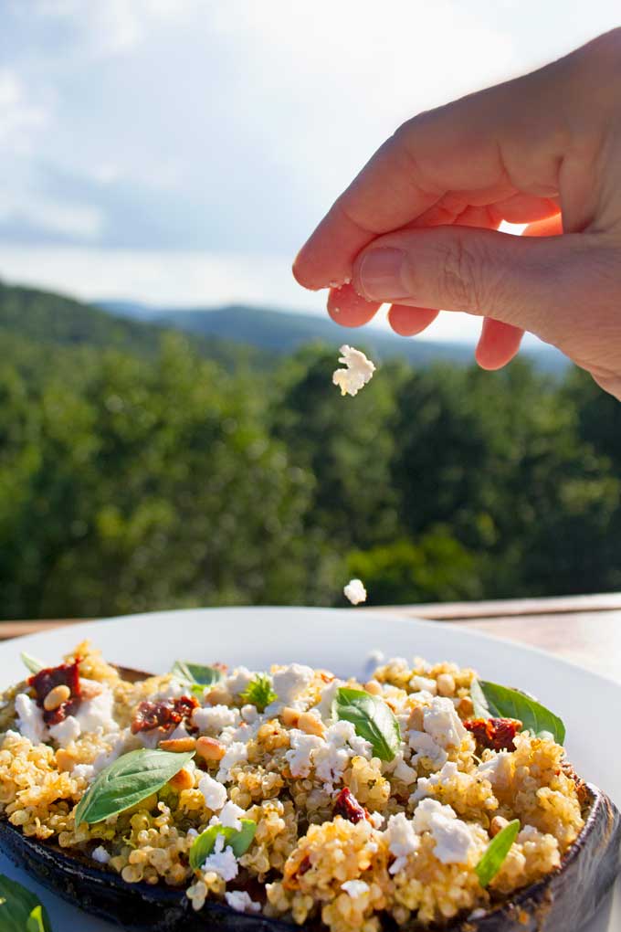 sprinkling feta onto eggplant