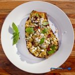 Mediterranean quinoa-stuffed eggplant on plate