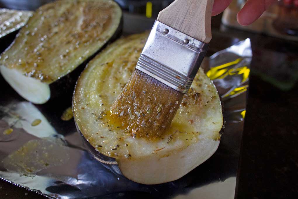 brushing eggplant with seasoned oil