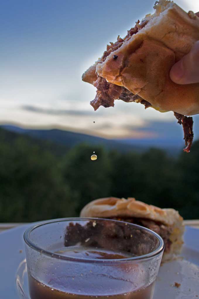dripping smoked brisket French Dip sandwich with mountain view