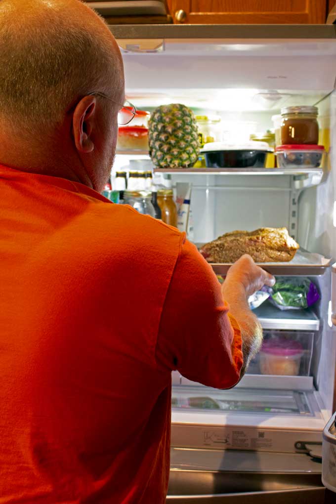 David putting rubbed brisket in fridge for smoked brisket french dip sandwich