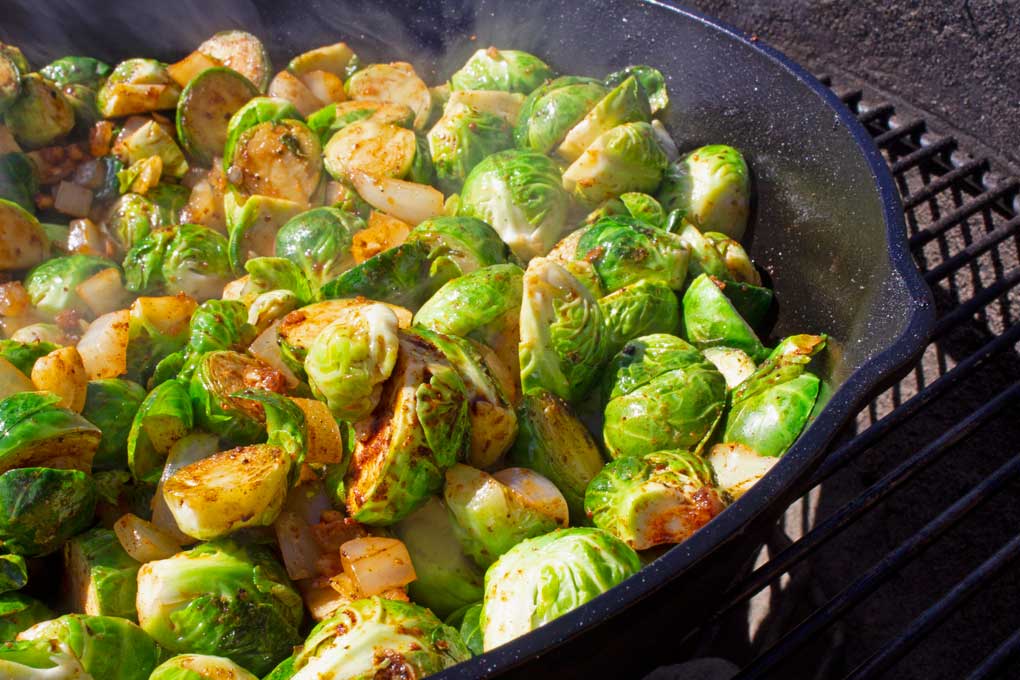 grilled brussels sprouts in pan on grill