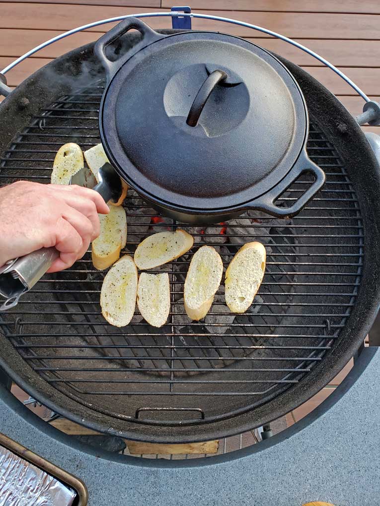 bread on grill with cast iron Dutch oven