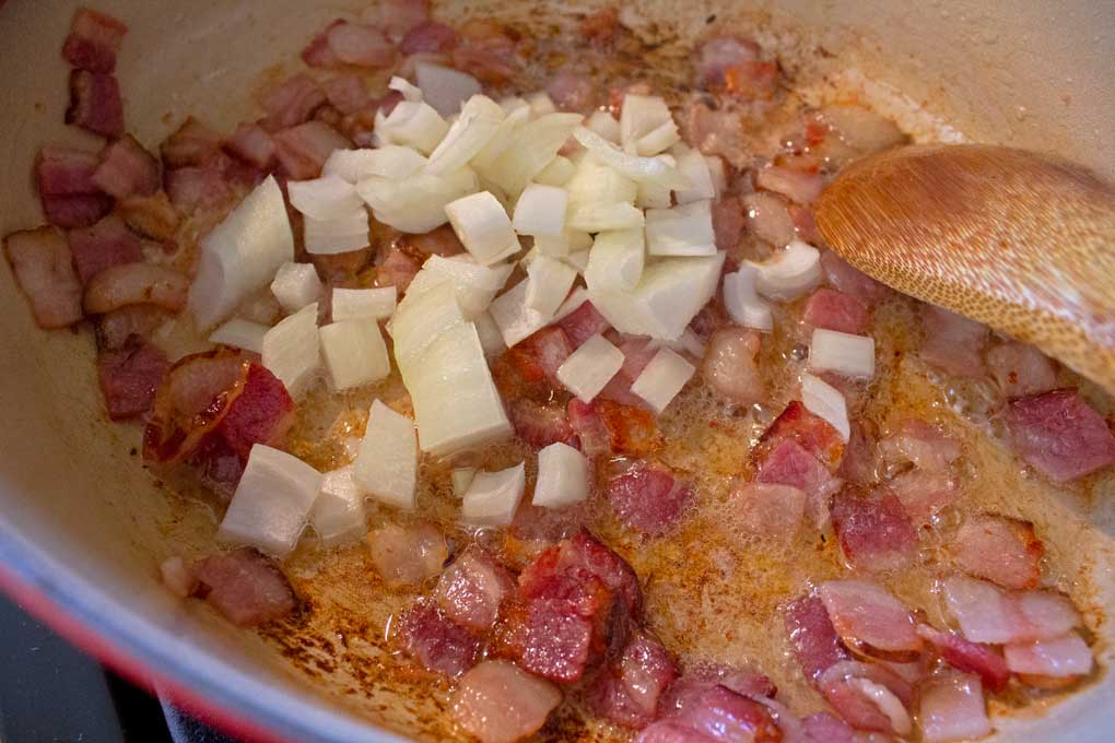 bacon and onions cooking in Dutch oven