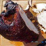 brined hickor-smoked turkey breast sliced on cutting board