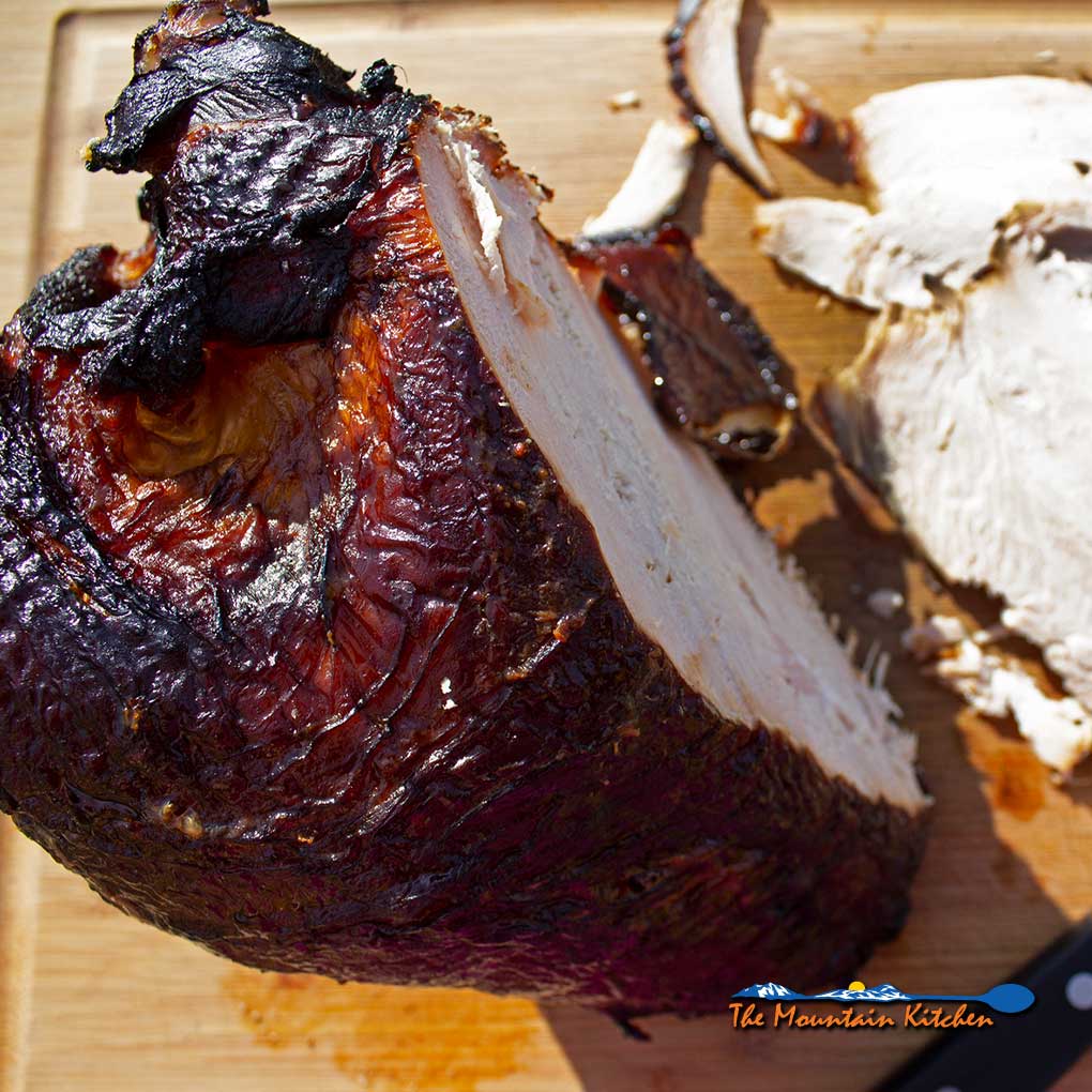 brined hickor-smoked turkey breast sliced on cutting board