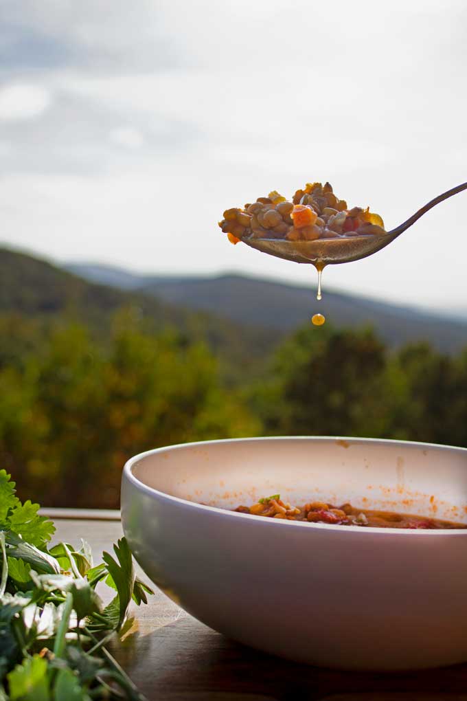 spoonful of soup with mountain view