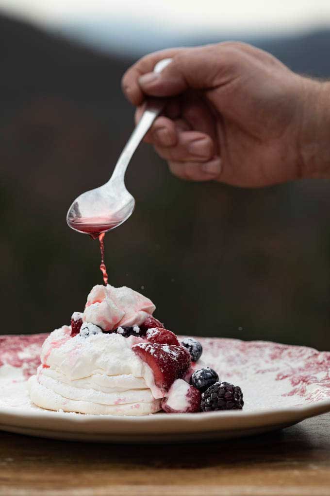 drizzling berry juice onto dessert