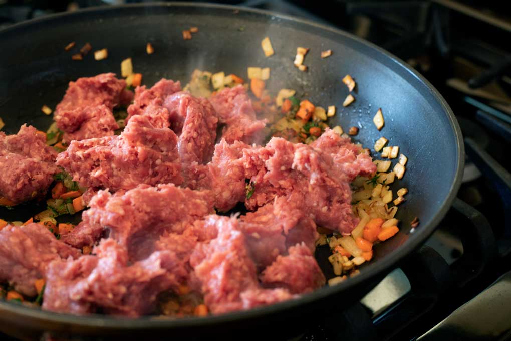 ground lamb cooking in skillet