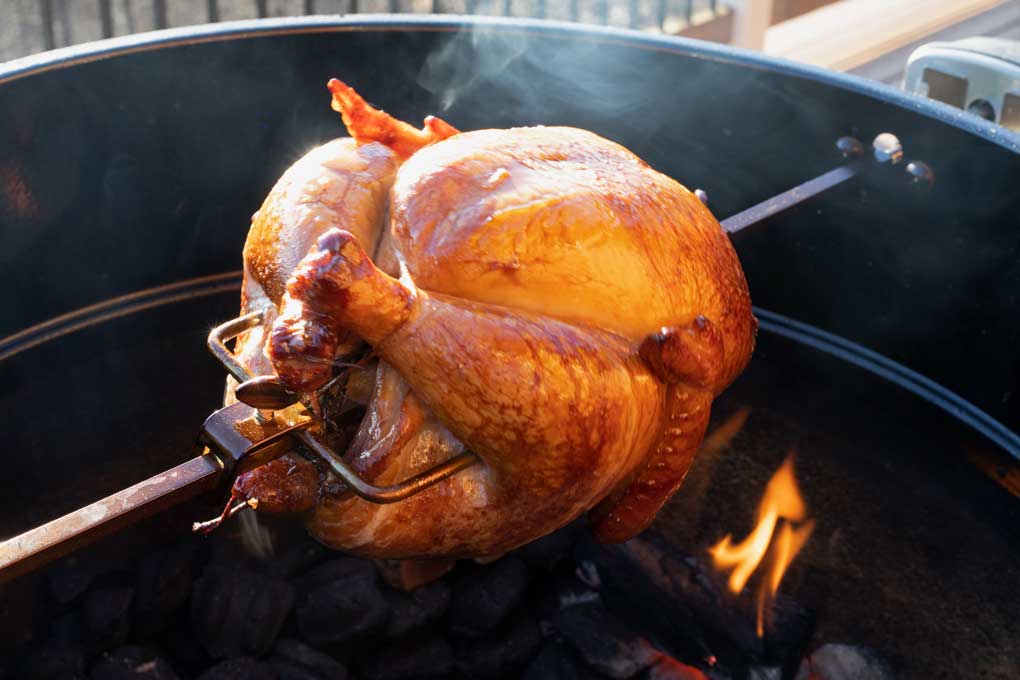 rotisserie-smoked chicken on grill