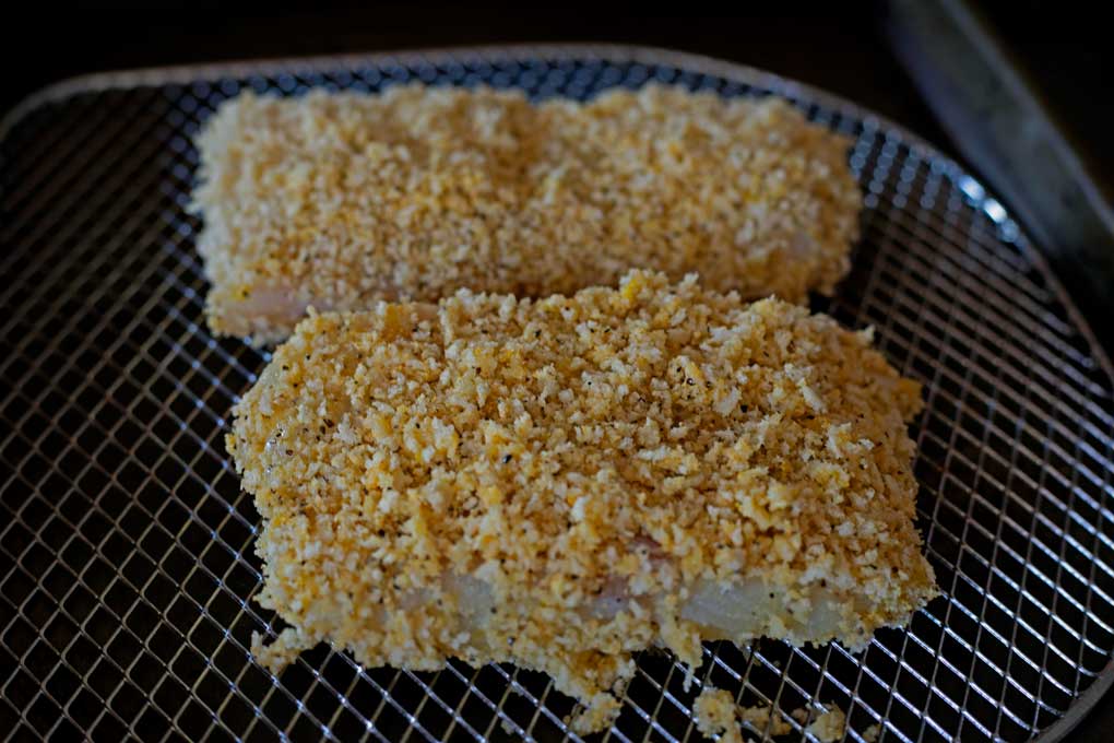 cod fillets on air fryer rack ready to cook