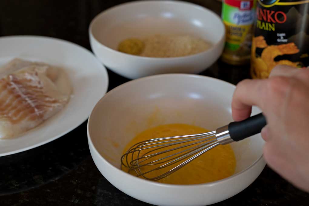 whisking egg in bowl