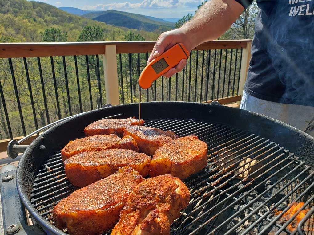 checking temperature of pork chop with instant-read thermometer