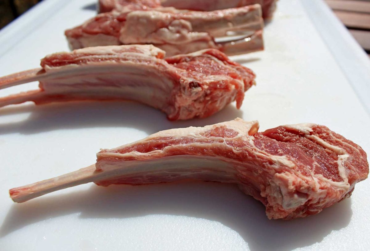 raw lamb chops on platter