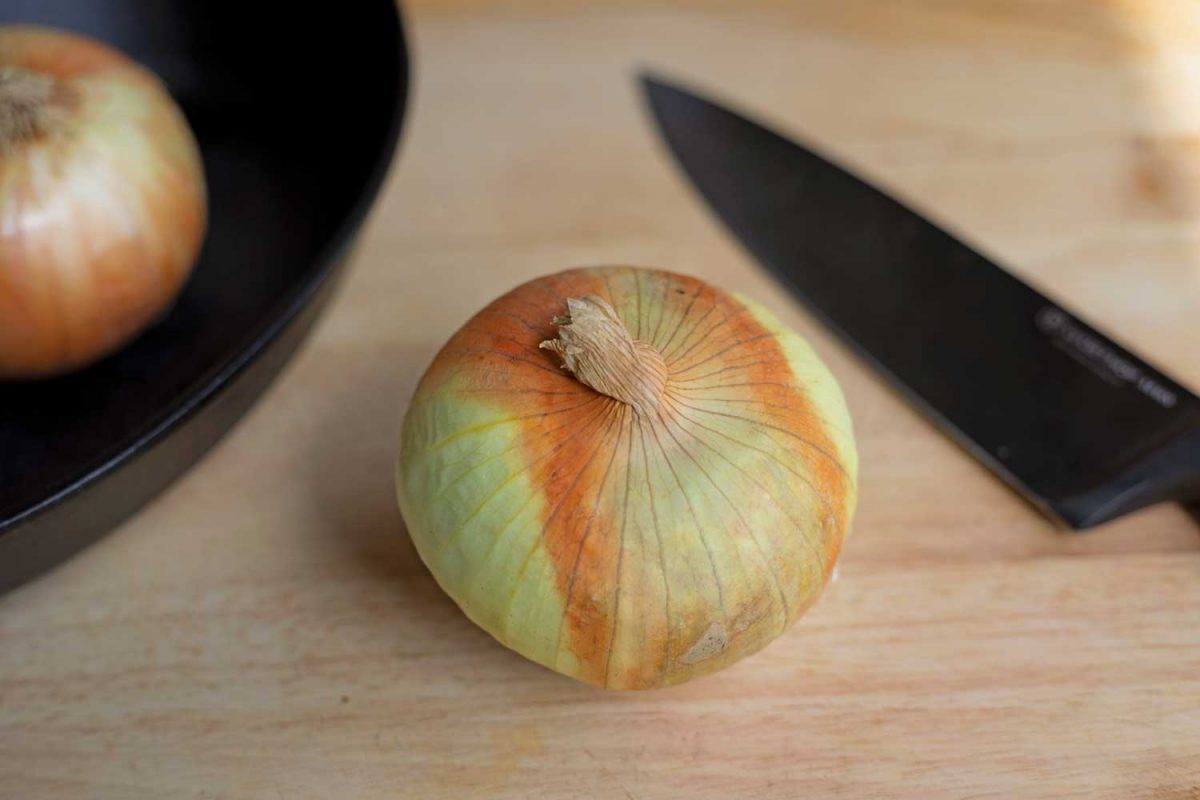 onion on cutting board with knife