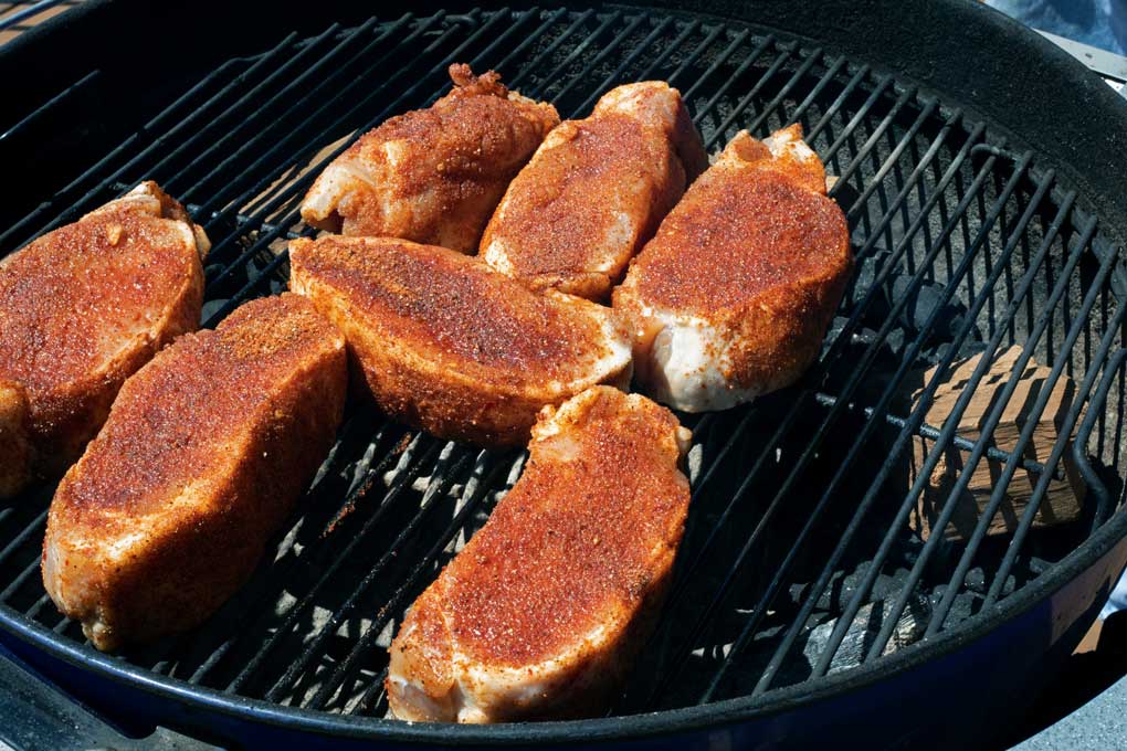 pork chops smoking on grill
