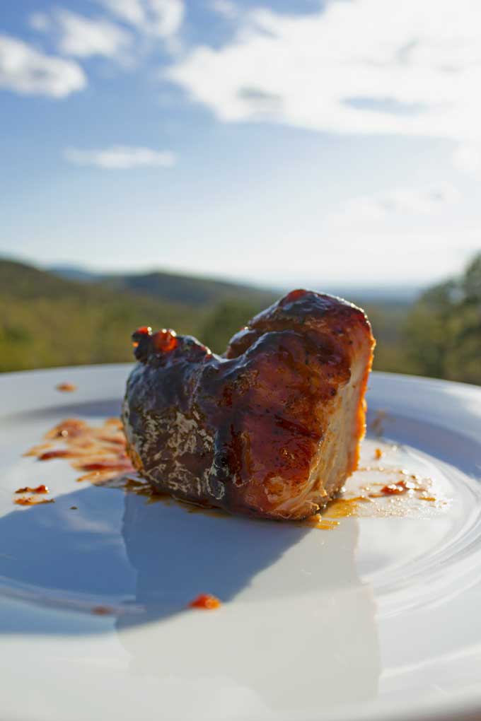 smoked pork chop on plate with mountain view