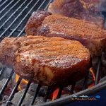 smoked pork chops searing on grill